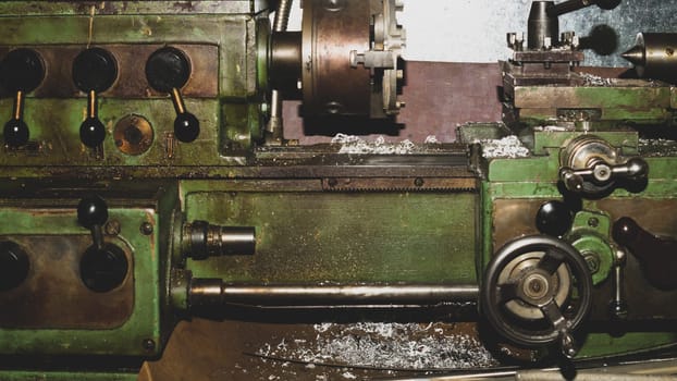 Old lathe. detail of rusty machine. metal mechanism. vintage metalworking machine close up. abstract industrial background