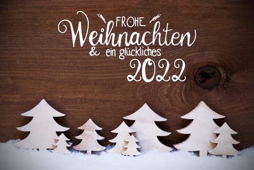 German Calligraphy Frohe Weihnachten Und Ein Glueckliches 2022 Means Merry Christmas And Happy 2022. White Wooden Trees On Snow WIth Wooden Background