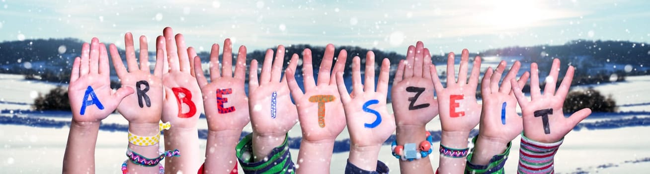 Children Hands Building Colorful German Word Arbeitszeit Means Working Hours. Snowy Winter Background With Snowflakes