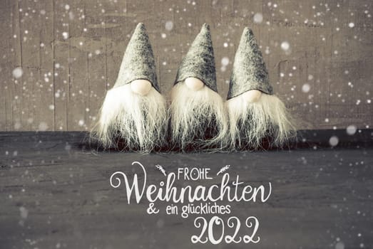 German Calligraphy Frohe Weihnachten Und Ein Glueckliches 2022 Means Merry Christmas And A Happy 2022. Thress Santa Claus With Hat And Concrete Background.
