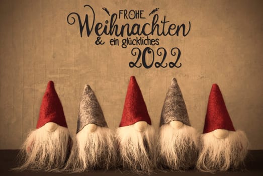 Five Santa With Hat. Concrete Background With German Calligraphy Frohe Weihnachten Und Ein Glueckliches 2022 Means Merry Christmas And A Happy 2022