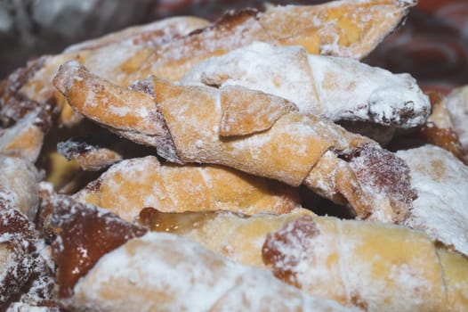 Crispy croissants stuffed with jam. traditional slavic pastry called roguelikes. crumbly cookies