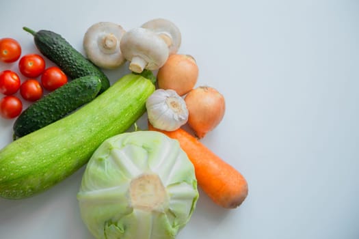Vegetables and porcini mushrooms lie on a white background. High quality photo