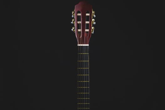 Guitar fretboard on black background. acoustic musical instrument. copy space