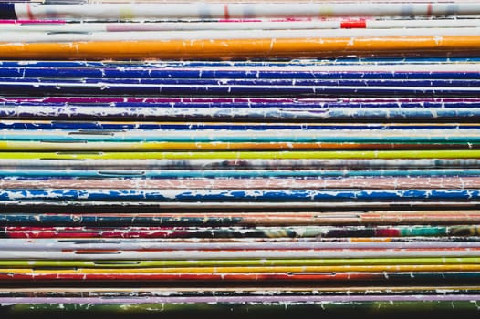 Stack of old magazines. pile of retro newspapers. vintage journals lie on top of each other. colorful background from the printed publications