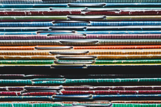 Stack of old magazines. pile of retro newspapers. vintage journals lie on top of each other. colorful background from the printed publications