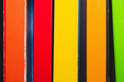 Stack of colorful books. spine of the book close up. abstract background