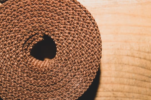 Industrial harness rolled up on a wooden table. work tool