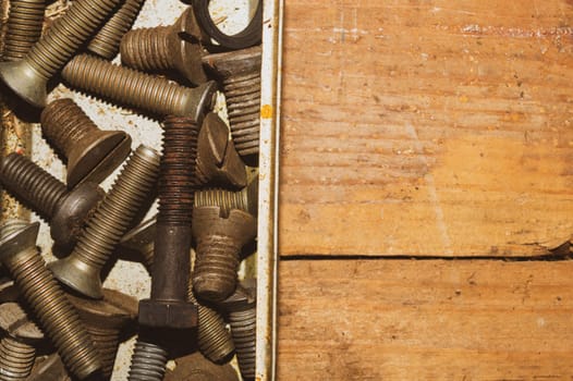 Old screws in a box. a lot of various screws. pile of fasteners in the box close up. carpentry workshop. work tool
