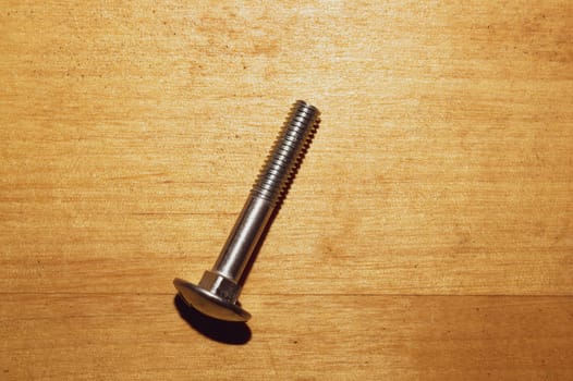 Screw on a wooden background.working tools. copy space