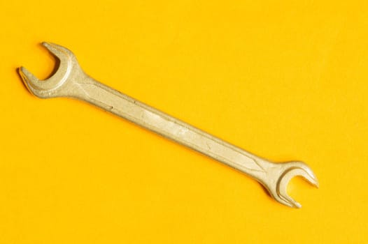Wrench isolated on yellow background with copy space. working tool