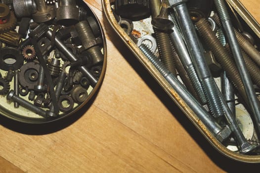 Old screws in a box. a lot of various screws. pile of fasteners in the box close up. carpentry workshop. work tool