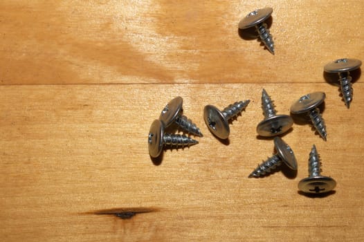 Screws on a wooden background.working tools. copy space