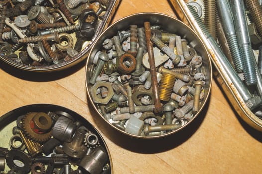 Old screws in a box. a lot of various screws. pile of fasteners in the box close up. carpentry workshop. work tool