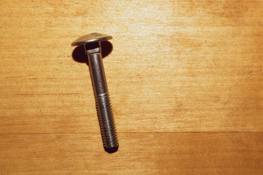 Screw on a wooden background.working tools. copy space