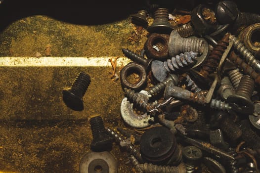 Old screws in a box. a lot of various screws. pile of fasteners in the box close up. carpentry workshop. work tool