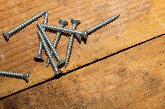 Screws on a wooden background.working tools. copy space