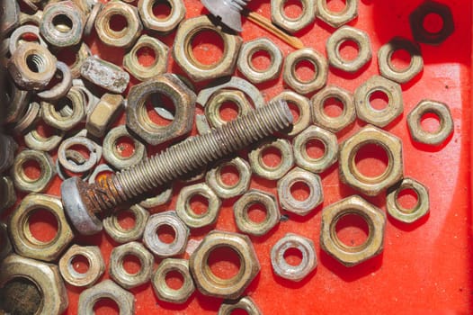 Old screws in a box. a lot of various screws. pile of fasteners in the box close up. carpentry workshop. work tool