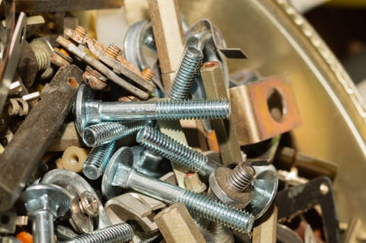 Old screws in a box. a lot of various screws. pile of fasteners in the box close up. carpentry workshop. work tool