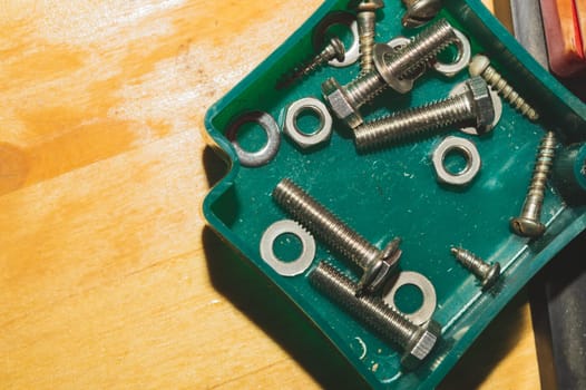 Old screws in a box. a lot of various screws. pile of fasteners in the box close up. carpentry workshop. work tool