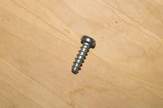 Screw on a wooden background.working tools. copy space