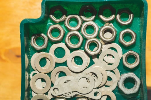 Old screws in a box. a lot of various screws. pile of fasteners in the box close up. carpentry workshop. work tool