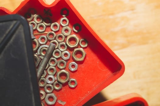 Old screws in a box. a lot of various screws. pile of fasteners in the box close up. carpentry workshop. work tool