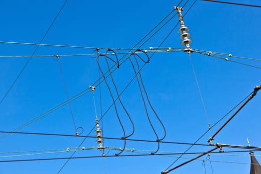 catenary of train under clear blue sky