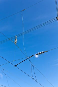 catenary of train under clear blue sky