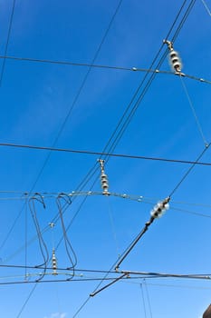 catenary of train under clear blue sky