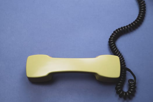 Telephone handset. phone receiver on blue background. old communication technology. copy space