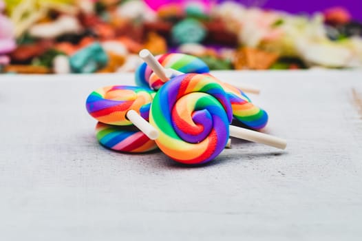 Lollipops on white wooden background. colorful candies close up. copy space