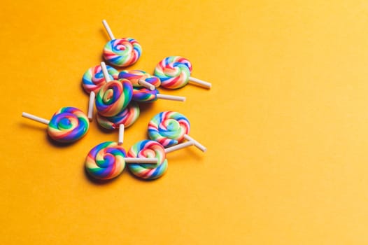 Lollipops close up. colorful candies on a yellow background. festive decoration. copy space