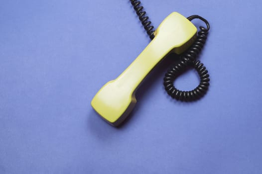 Telephone handset. phone receiver on blue background. old communication technology. copy space