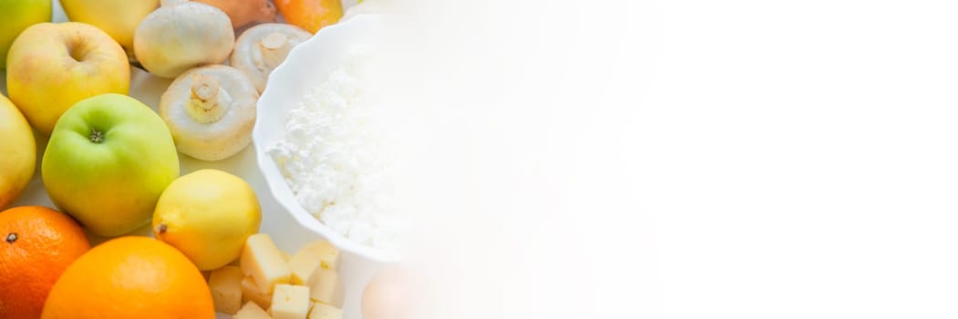 Fruits, vegetables and dairy products lie next to each other with a place for text. High quality photo