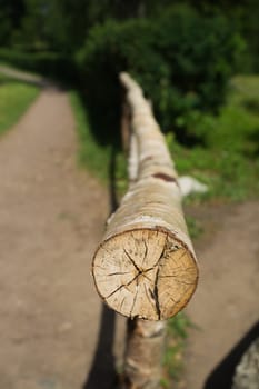 Wooden log fence. handrails from wood. rural scene
