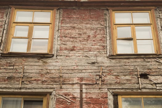 Windows of the old wooden house. wooden plank wall with windows background