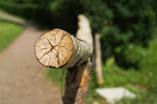 Wooden log fence. handrails from wood. rural scene