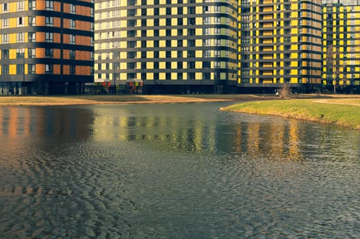 Modern buildings with lake and park. new constructed colorful building. modern residential construction