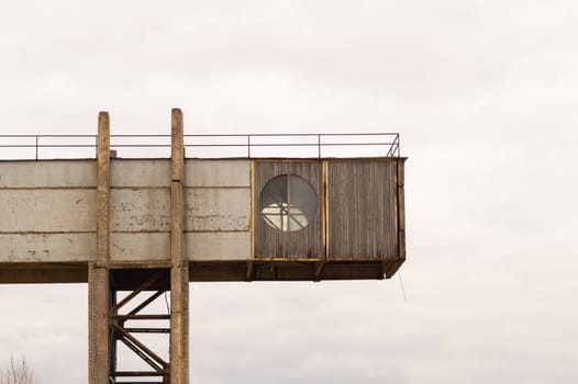 Part of a factory with round window on the sky background. industrial backdrop