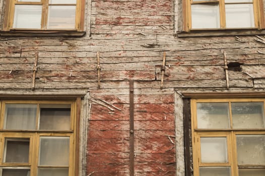 Windows of the old wooden house. wooden plank wall with windows background