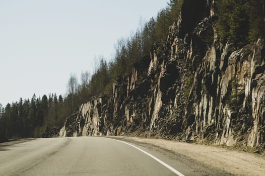 Mountain road. highway in mountains. rocky cliff on the side of roadway