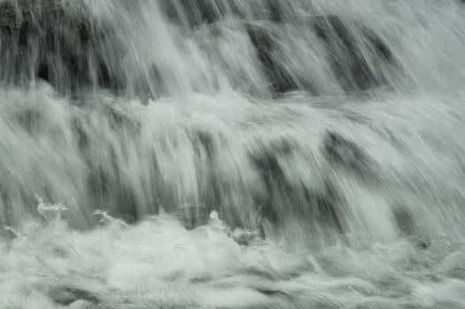 Waterfall background. rushing stream water. abstract backdrop