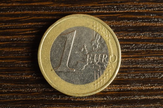 Euro coin on a dark wooden background. european money