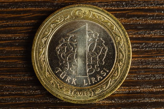 Turkish coin on a dark wooden background. lira from Turkey close up