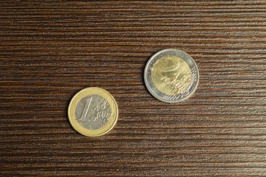 Euro coins on a dark wooden background. european money