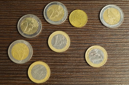 Euro coins on a dark wooden background. european money