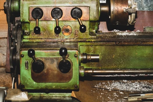 Old lathe. detail of rusty machine. metal mechanism. vintage metalworking machine close up. abstract industrial background