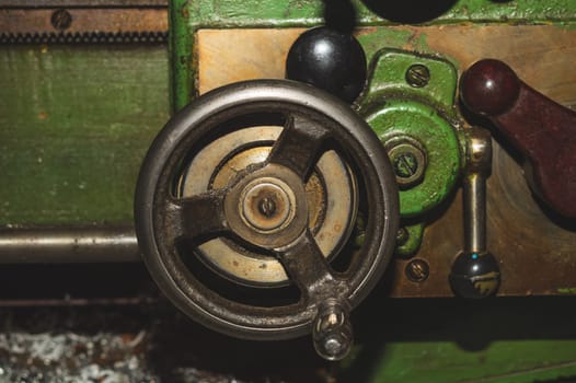 Old lathe. detail of rusty machine. metal mechanism. vintage metalworking machine close up. abstract industrial background