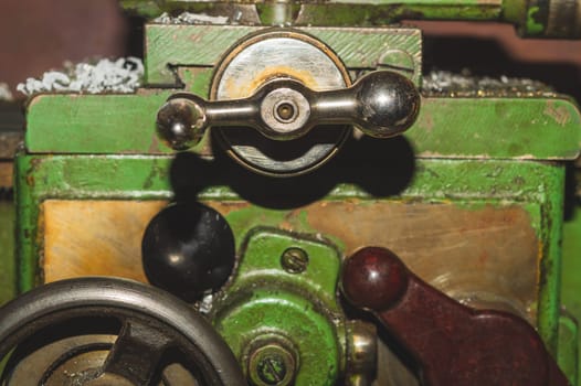 Old lathe. detail of rusty machine. metal mechanism. vintage metalworking machine close up. abstract industrial background
